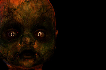 Creepy evil looking doll. Reflected in its eyes is a trace of light forming a pentagram.. Copy...
