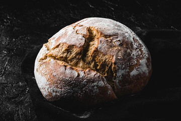 dark homemade bread dusted with flour