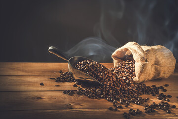 Coffee cup and Coffee beans spread on the table wooden old with copys for your text