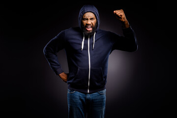 Photo of furious afro american guy raise fists encourage stop racism wear jumper denim jeans...