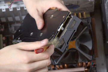 Fototapeta na wymiar Repair of PC cleaning of video card from dust using brush