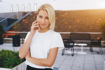 Smiling female lawyer is talking on mobile phone about her winning trial