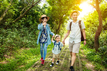 happy family hiking through the forest