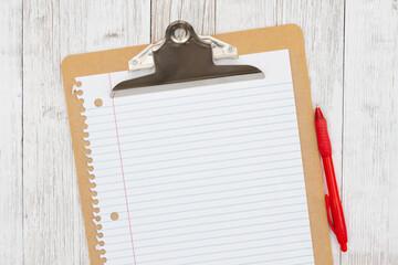 Clipboard with blank paper and pen on weathered whitewash wood background