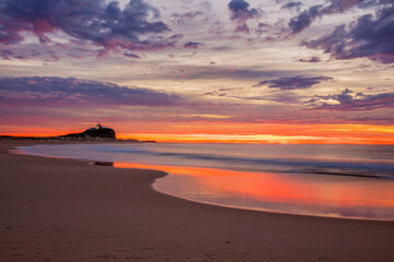 Beautiful winter's sunrise over Nobbys  Beach and Lighthouse. Newcastle,  east coast of N.S.W. of Australia.