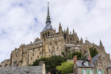 Obraz premium Abbey Mont Saint-Michel (VII century) at rocky tidal island in Normandy - one of most visited tourist sites in France. Normandy, Northern France, Europe.