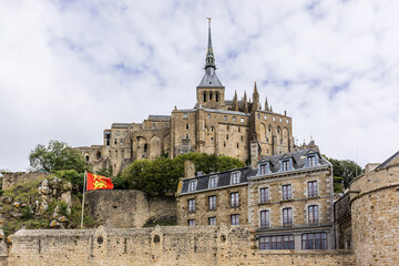 Fototapeta premium Abbey Mont Saint-Michel (VII century) at rocky tidal island in Normandy - one of most visited tourist sites in France. Normandy, Northern France, Europe.