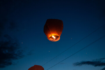 Running paper lanterns in the night sky