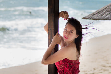 Portrait of a beautiful girl on the beach under an umbrella.