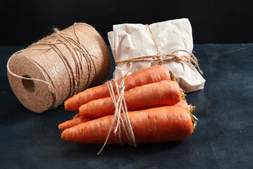 Fresh carrots, dark background. Copy space, close-up, photo for a grocery store