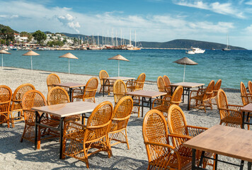 An empty cafe by the sea in the resort town is waiting for guests and clients, empty city spaces....