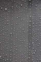 Raindrops on gray metal surface