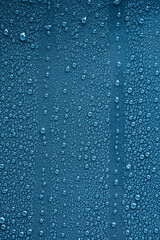 Raindrops on blue metal surface