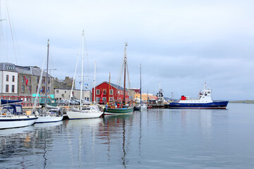 Fototapeta na wymiar Harbour with fishing boats, lifeboat & buildings in the background, Lerwick, Shetland Islands, Scotland.