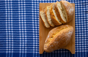 Homemade bread on blue and white plaid background