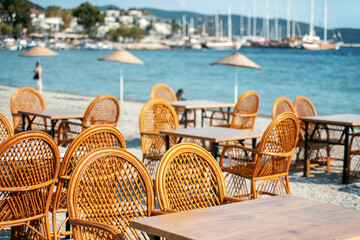 An empty cafe by the sea in the resort town is waiting for guests and clients, empty city spaces. Summer vacation concept
