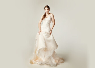 Fototapeta premium girl in a nude dress with tulle with lace on a white background