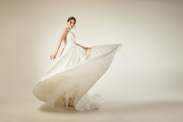 girl in a white satin dress with lace on a white background