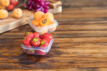 Fresh strawberries on old wooden background in glass bowl