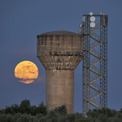 high water tank and full moon of honey in Mollina, Malaga. Spain