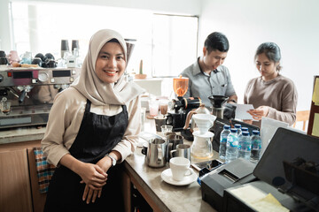 barista smiling when make a coffee for a customer in coffee house