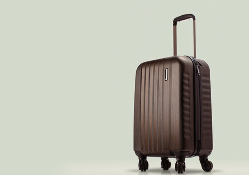 suitcase standing on colored background