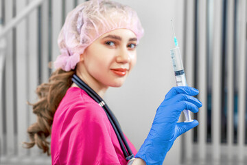 Doctor hands holding a syringe closeup on the background of the doctor s office. Kocentpt surgery,...