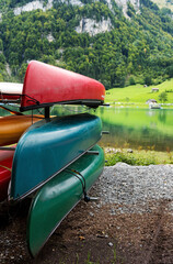 Canoes stacked on the mountain lake shore in Switzerland.