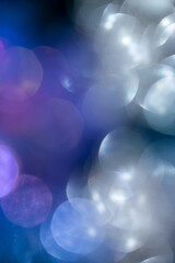 Abstract bokeh on blue-purple background.