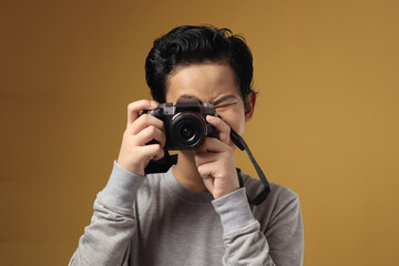 Happy Asian boy doing photography