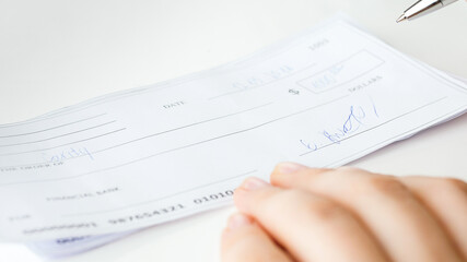 Closeup image of filled and signed banking cheque