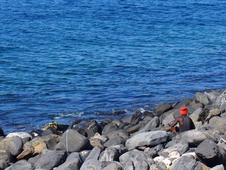 Senegalese man gazing out at the bright blue sea, Goree Island, Dakar, Senegal