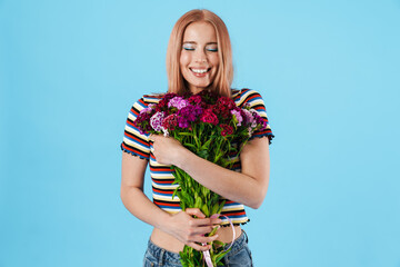 Image of cheerful beautiful pretty girl posing with flowers and smiling