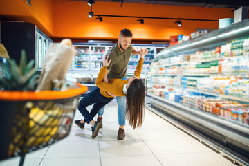 Love family couple dancing in grocery store
