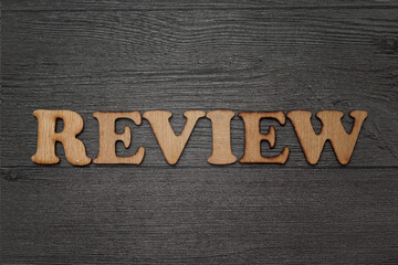 Naklejka premium Review words text, wooden alphabet typography lettering