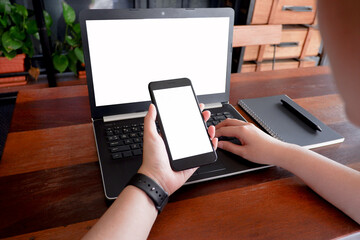 Cropped shot view of business woman’s hands typing the labtop with blank copy space screen for your information content or text message.