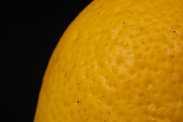 Half a lemon macro, macro photo, green, black background, healthy food. vegan food, organic food