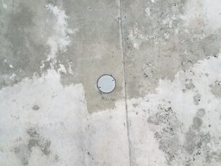 metal circle with the word power on grey cement ceiling
