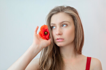 Portarait attractive young girl with red poppy