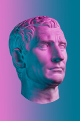 Statue of Guy Julius Caesar Octavian Augustus. Creative concept colorful neon image with ancient roman sculpture Guy Julius Caesar Octavian Augustus head. Cyberpunk, vaporwave and surreal art style. - obrazy, fototapety, plakaty