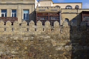 Fragment of an ancient stone wall and the old city