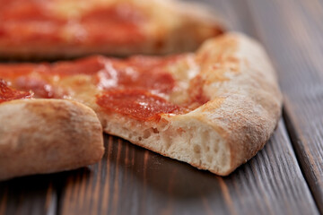 tasty pizza on the wooden background