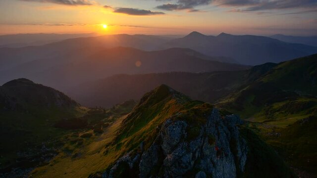 Time lapse of brilliant sunrise above rocks in the Carpathian mountains.