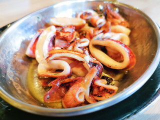 Fresh Grilled octopus served in vintage metallic pan for a mediterranean meal