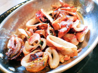Fresh Grilled octopus served in vintage metallic pan for a mediterranean meal