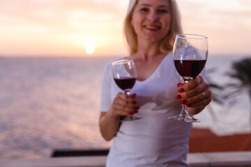 Woman admiring sunset from her balcony