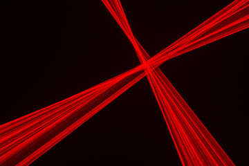 Abstract red lines drawn by light on a black background.