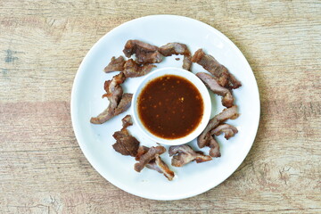 roasted pork slice dipping spicy and sweet tamarind sauce on plate