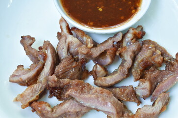 roasted pork slice dipping spicy and sweet tamarind sauce on plate