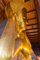Reclining big Buddha gold statue in Wat Pho, Bangkok, Thailand